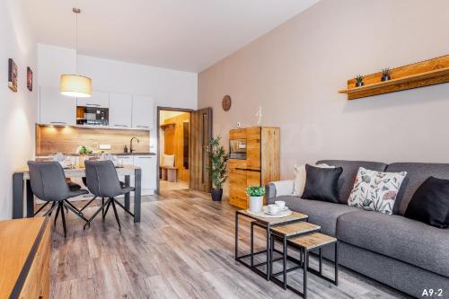 a living room with a couch and a table at KORZO LIPNO 2 in Lipno nad Vltavou