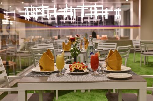 a table with plates of food on top at Click Hotel Pithampur in Mhow