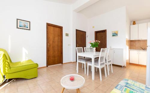 salon ze stołem i żółtym krzesłem w obiekcie Apartments MARIJA w mieście Okrug Donji