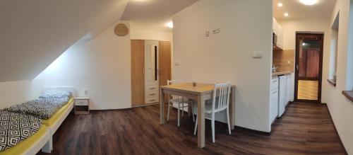 a bedroom with a bed and a table in a room at Penzion Bystřička in Vsetín