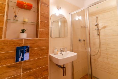 a bathroom with a sink and a shower at Apartmány Skihouse Jasná in Demanovska Dolina