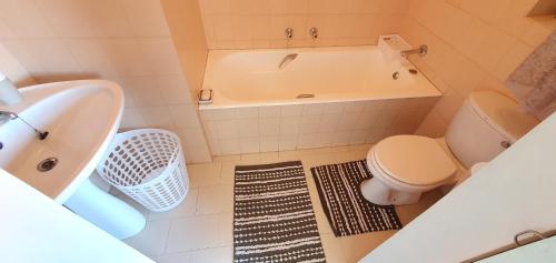 a bathroom with a tub and a toilet and a sink at Milton Lane Beach club 5 - 6 Sleeper - Ideal Location! in Margate