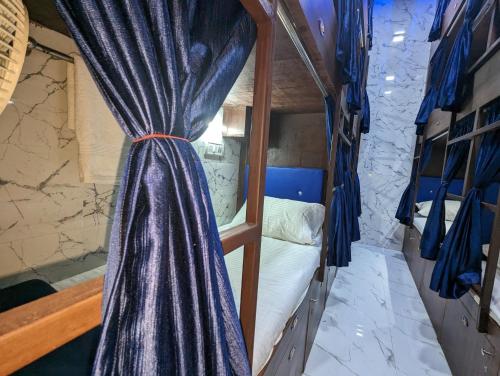 a bunk bed with a curtain in a room at Ayala PG Dormitory Ac Deluxe1 in Mumbai