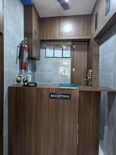 a reception desk in a room with a fire extinguisher at Ayala PG Dormitory in Mumbai