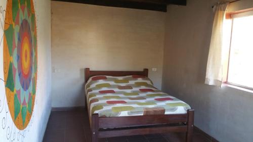ein kleines Bett in einem Zimmer mit Fenster in der Unterkunft Casa Amanecer in Samaipata