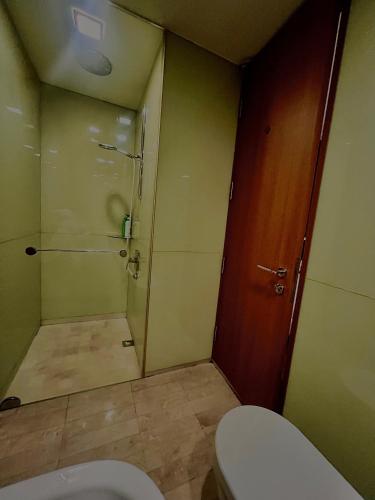 a bathroom with a shower and a toilet in it at SOHO Suites KLCC in Kuala Lumpur