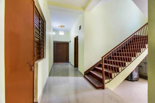 a hallway with a staircase in a house at OYO Flagship Adam's Bridge International Hotel in Patna