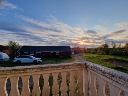 a house with a car parked in front of it at Mäki-mummola in Ylitornio