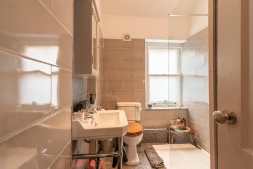 a small bathroom with a sink and a toilet at Spacious Country Cottage Sleeps 6 Near Bath +Fire Pit + Dog Friendly in Bradford on Avon
