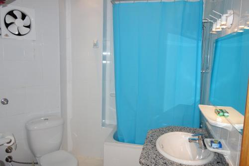 a bathroom with a sink and a toilet and a shower at Blue Vision Diving Hotel in Marsa Alam City