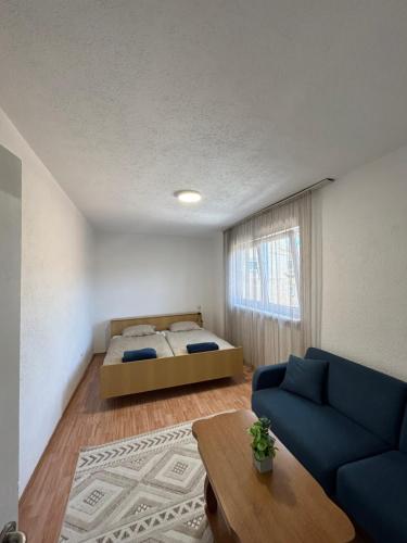 a bedroom with a bed and a couch and a table at The heart of Sarajevo in Sarajevo