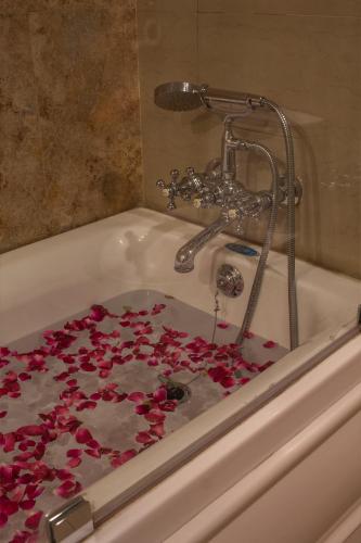 a bath tub filled with red rose petals at Hotel Rock Manali -A Unit of Akhnoor Hotels Pvt Ltd in Manāli
