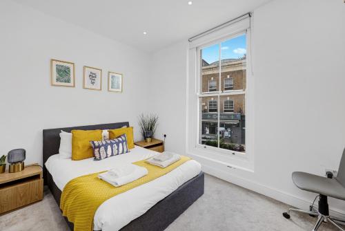 a bedroom with a bed and a window at New 1 Bedroom flat right on Broadway Market! in London