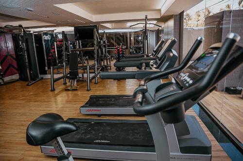 a gym with several treadmills and cardio machines at Unity Beira Mar de João Pessoa by Carpediem in Penha