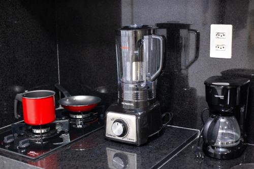 a blender sitting on top of a counter at Unity Beira Mar de João Pessoa by Carpediem in Penha