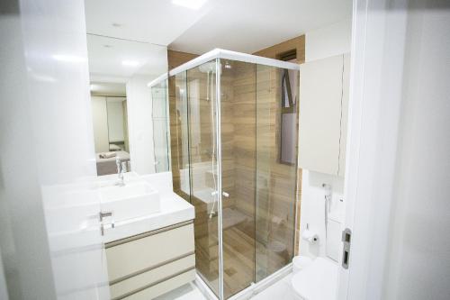 a bathroom with a shower and a sink at Unity Beira Mar de João Pessoa by Carpediem in Penha