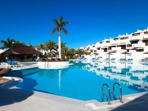 a swimming pool in front of a resort at Idaira Paradise in Playa Paraiso