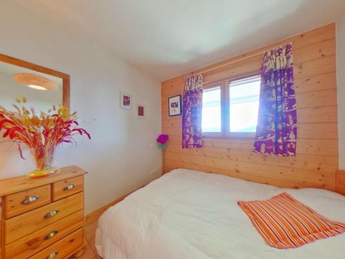 a bedroom with a bed with a dresser and a window at Appartement Villard-sur-Doron, 3 pièces, 8 personnes - FR-1-594-40 in Villard-sur-Doron