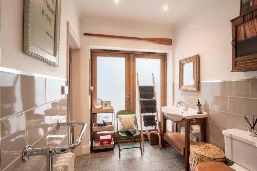 a bathroom with a sink and a shower and a toilet at Granby Estate The Old Pool House in Bradford on Avon