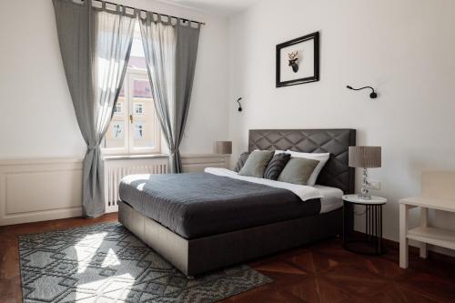 a bedroom with a bed and a window at LA apartments in Maribor