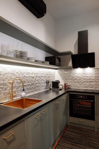 a kitchen with a sink and a counter top at Main Square Apartments & Rooms in Maribor
