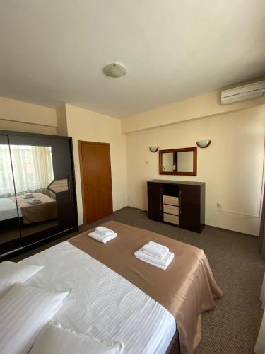 a hotel room with a bed and a mirror at Hotel Diana in Bistriţa