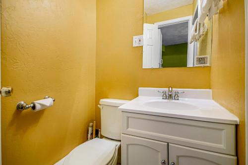 a bathroom with a white sink and a toilet at Arrowhead Resort: Canary Condo in Saugatuck