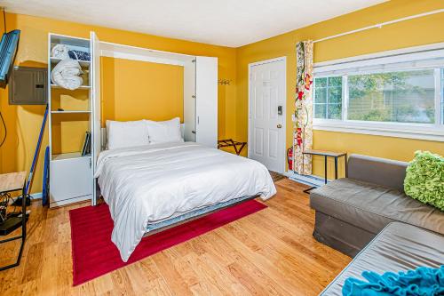 a bedroom with a bed and a couch at Arrowhead Resort: Canary Condo in Saugatuck