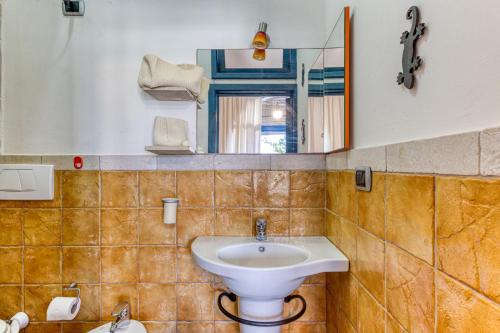 y baño con lavabo y espejo. en Villa Blu La Cambusa en Castro di Lecce