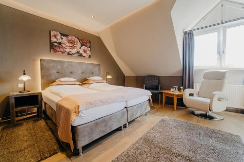 a bedroom with a large bed and a large window at Hotel Waldkrug in Delbrück