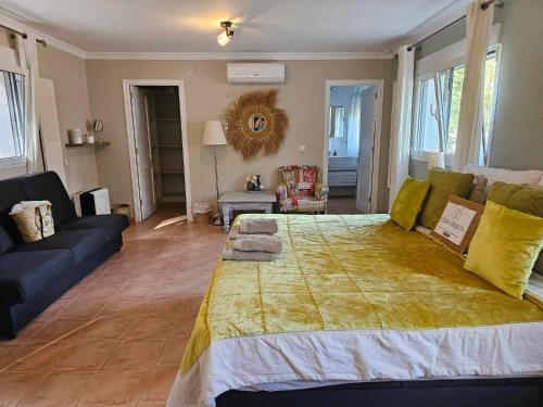 a bedroom with a large bed and a couch at CASA-ORBETA in Orba