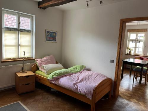 - une chambre avec un lit et une table dans l'établissement Haus Winterlinde mit herrlich verzaubertem StaudenGarten, 