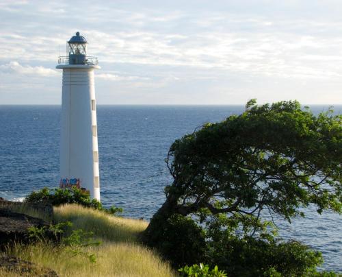 a lighthouse sitting on top of a hill next to the ocean at Bungalow d'une chambre avec jardin clos et wifi a Saint Louis in Saint-Louis