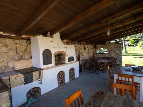 a patio with an outdoor oven in a house at Penzión Záruby in Smolenice
