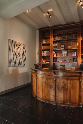 a large wooden desk in a room with shelves at Hotel PURS in Andernach