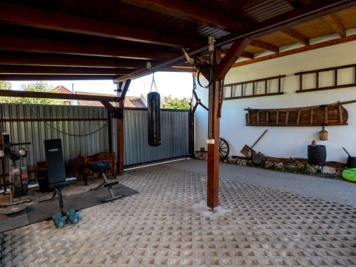 an open patio with a building with a fence at Penzión Záruby in Smolenice