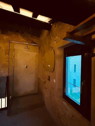 a room with a door and a window in a building at "PALAZZO SABBIONI" Romantic Apartment with Kitchen Park View in Ferrara