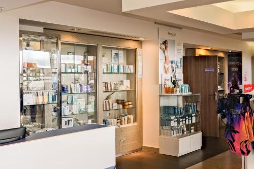 a store with several glass cases of medicines at Thalazur Cabourg - Hôtel & Spa in Cabourg