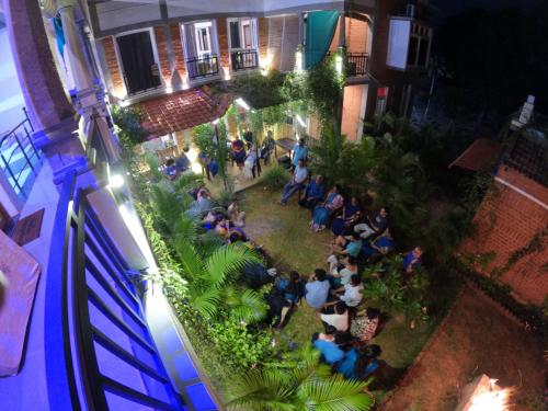 an overhead view of a group of people sitting in a yard at Wow Farm House in Auroville