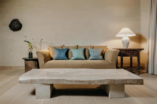 a living room with a couch with blue pillows at Hotel PURS in Andernach