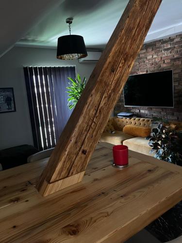 a large wooden table in a living room with a tv at NEW GUEST HOUSE 13 in Maribor
