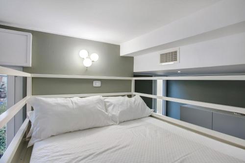 ミラノにあるAppartamento Robertaのベッドルーム1室(窓、白いベッド1台付)