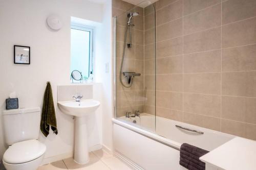 a bathroom with a toilet and a sink and a shower at Artist's Garden on Wolsey Island in Leicester