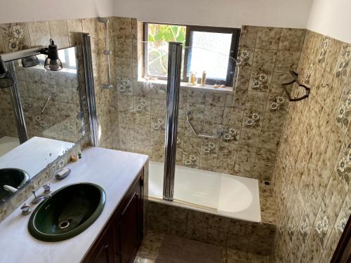 a bathroom with a sink and a shower and a tub at Cama da Vaca in Mato Porcas