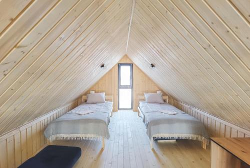 a room with three beds in a attic at Ostoja Radków całoroczny domek z balią in Wünschelburg