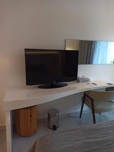 a desk with a computer monitor on top of it at TRYP by Wyndham Corfu Dassia in Dassia
