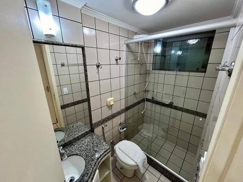 a bathroom with a shower and a toilet and a sink at Villas diRoma com um dia no Acqua Park, Splash e Slide in Caldas Novas