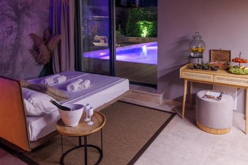 a bedroom with a bed and a pool in the background at Vila ROBIDA & SPA in Črni Kal