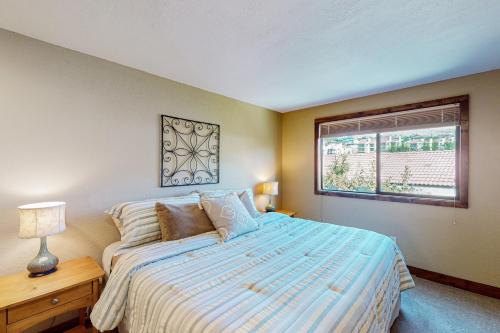 a bedroom with a large bed and a window at Lake Chelan Shores: Sandy Beach Delight #1-5 in Chelan