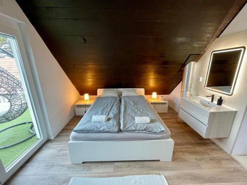 a small bedroom with a bed and a sink at Felix House Siófok in Siófok